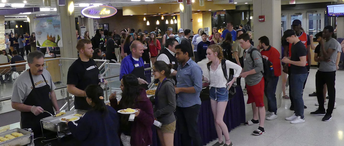 Students gathering in line to get foods in the late night breakfast event in CSU