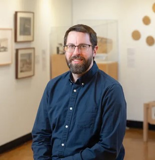 Photo of Patrick Heath sitting and smiling