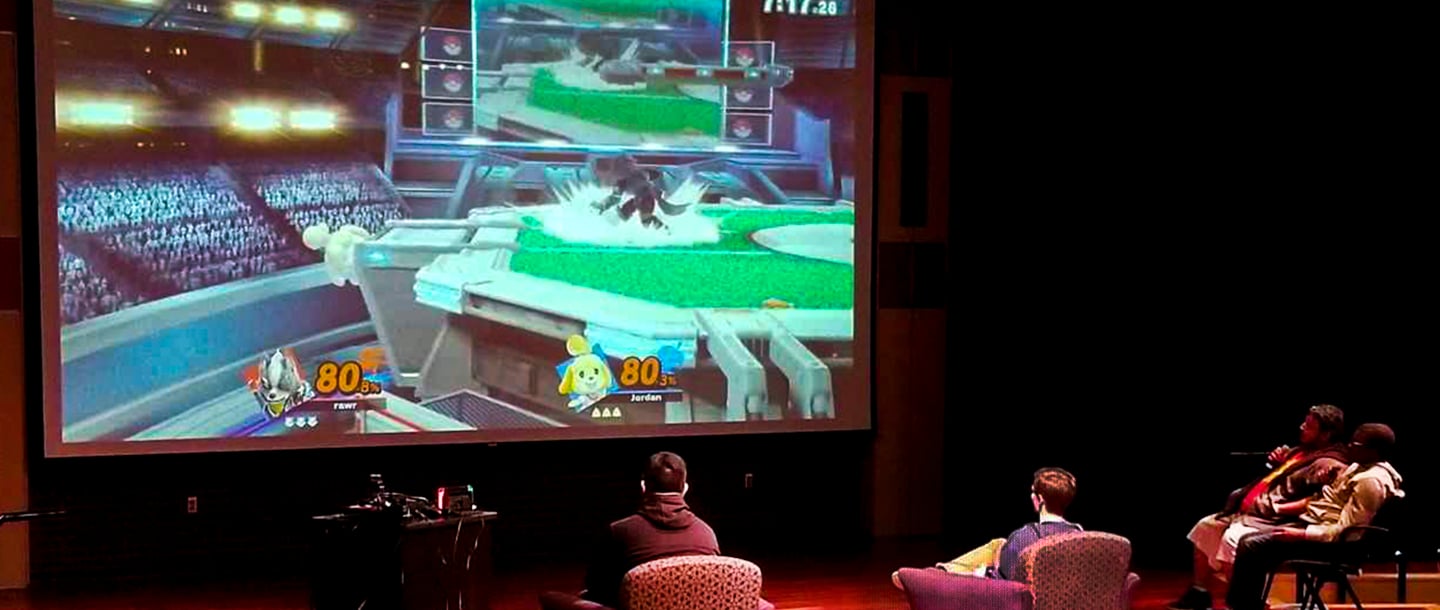 students are playing video games on a big screen