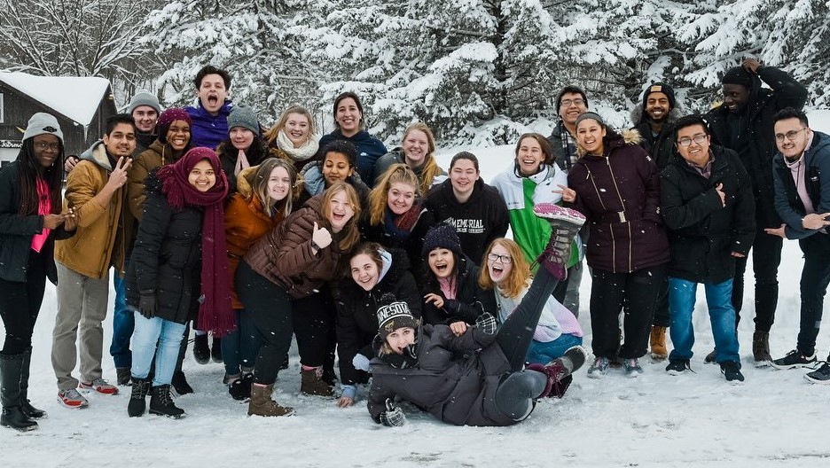 group of students posing to take picture in the snow