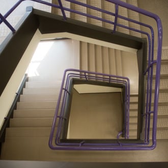 Top view of a spiral staircase with purple railings