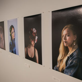 A row of portraits hanging on a wall