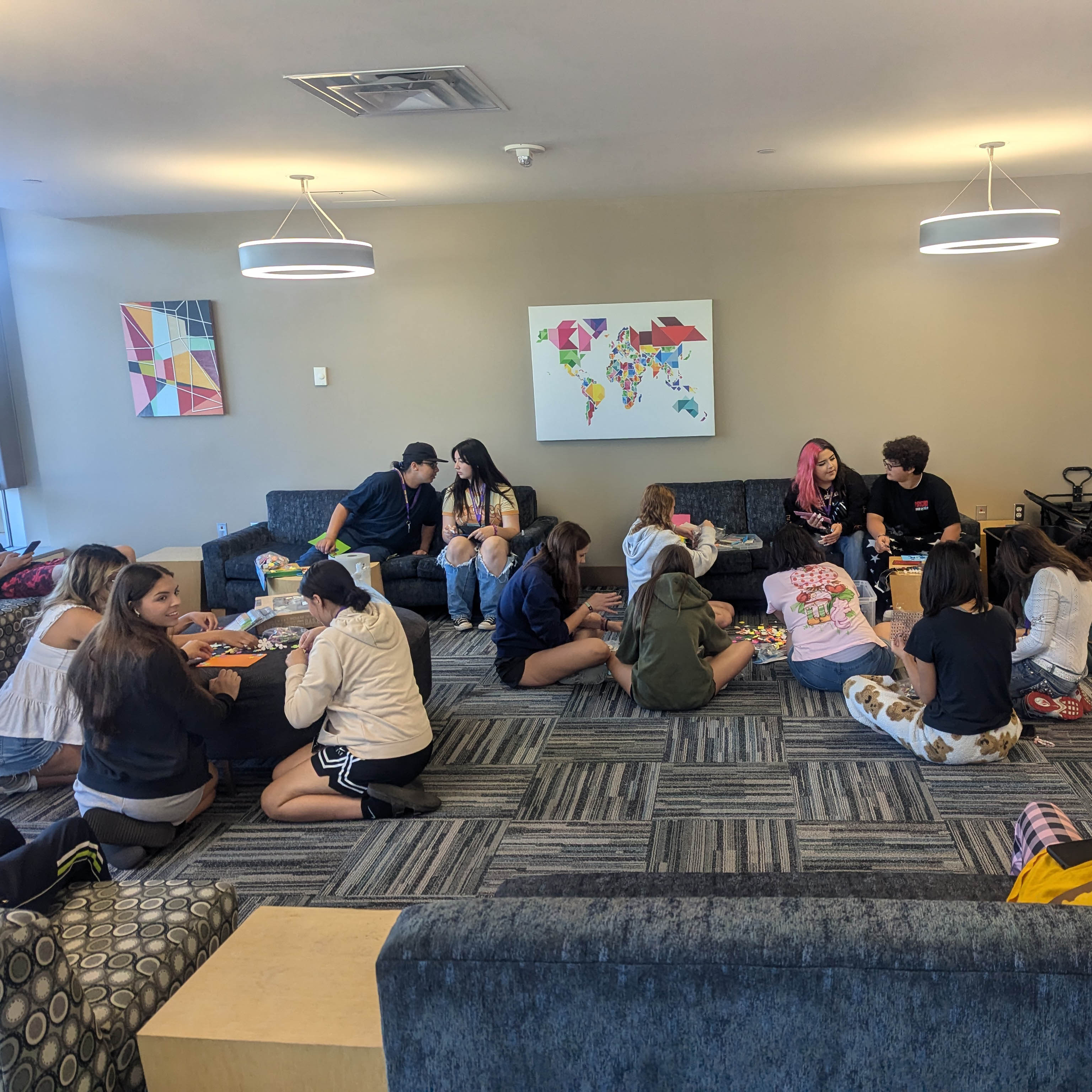 Students working in small groups in one of the lounges on campus