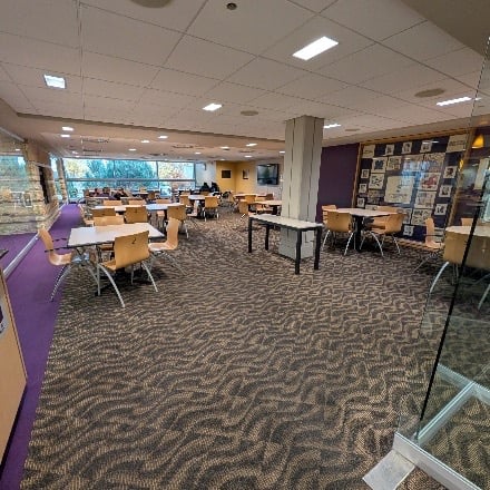 Open room with tables and chairs.