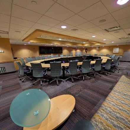 Meeting room with tables and chairs. 