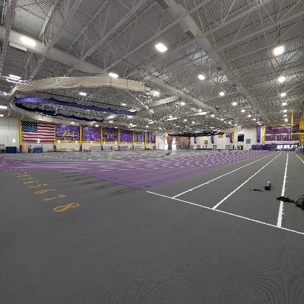 Indoor track with MSU branding along the side walls and the American Flag hanging on the far wall.
