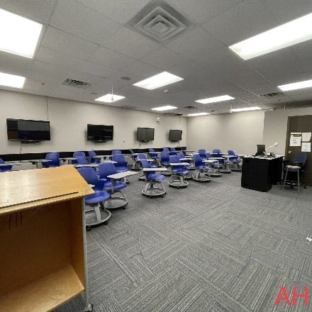 Classrooms set up with desks in rows and monitors along the wall.