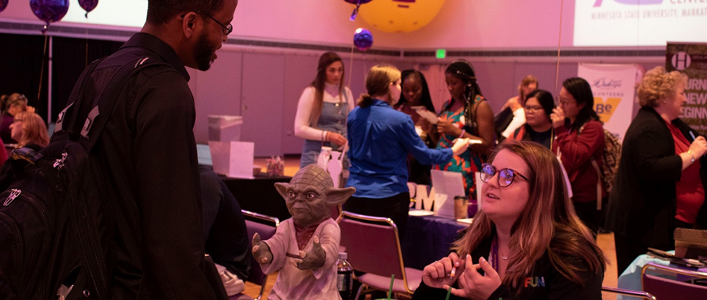 Employers Explaining Behind Yoda Statue