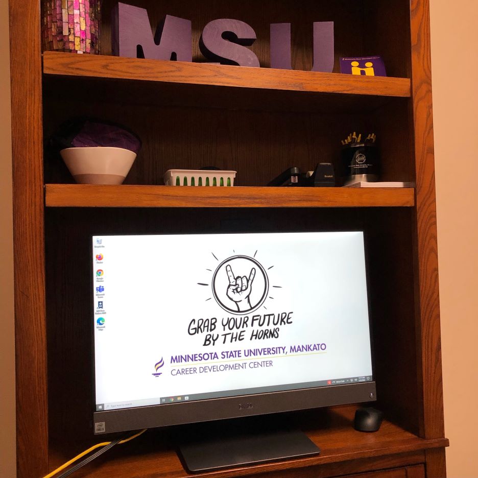 A computer monitor on a shelf saying 'grab your future by the horns' from the Minnesota State University, Mankato Career Development Center