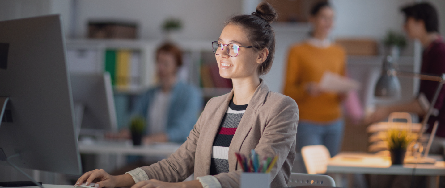 Women smiling while typing at computer