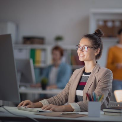 Women smiling while typing at computer
