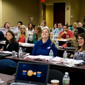 Customer experience professionals in a classroom setting during a certificate program 
