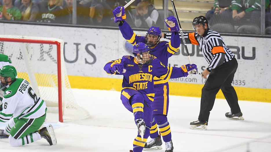 Two maverick hockey team players celebrating after a goal