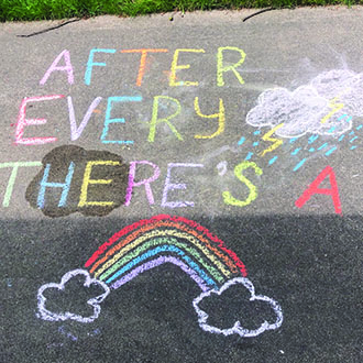a sidewalk with chalk writing on it