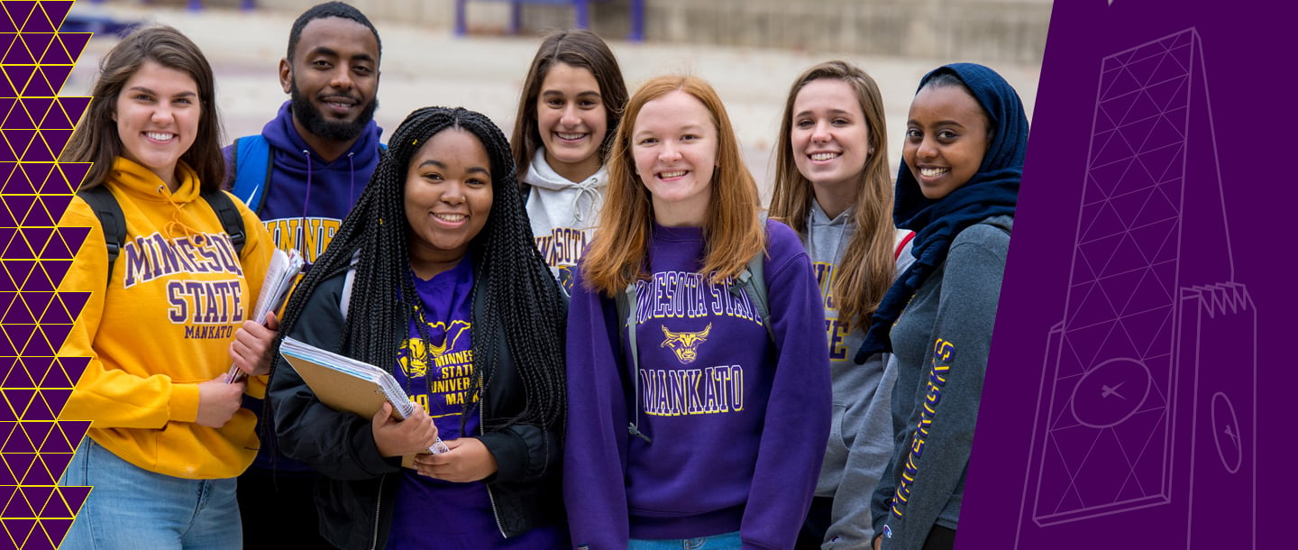 students posing and smiling wearing Minnesota State merchandise