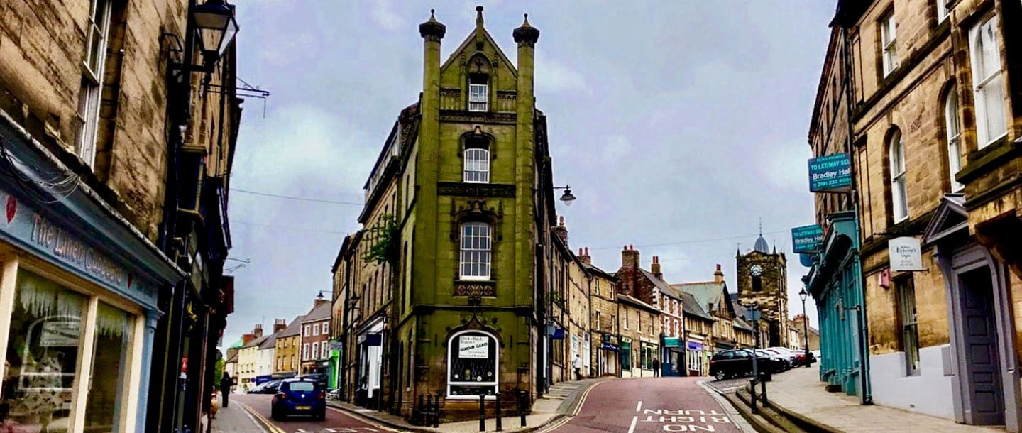 Street view of shops and pubs on Narrowgate in the Castle Quarter in Alnwick Northumberland England