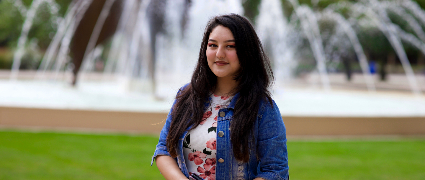 Student in front of Fountain
