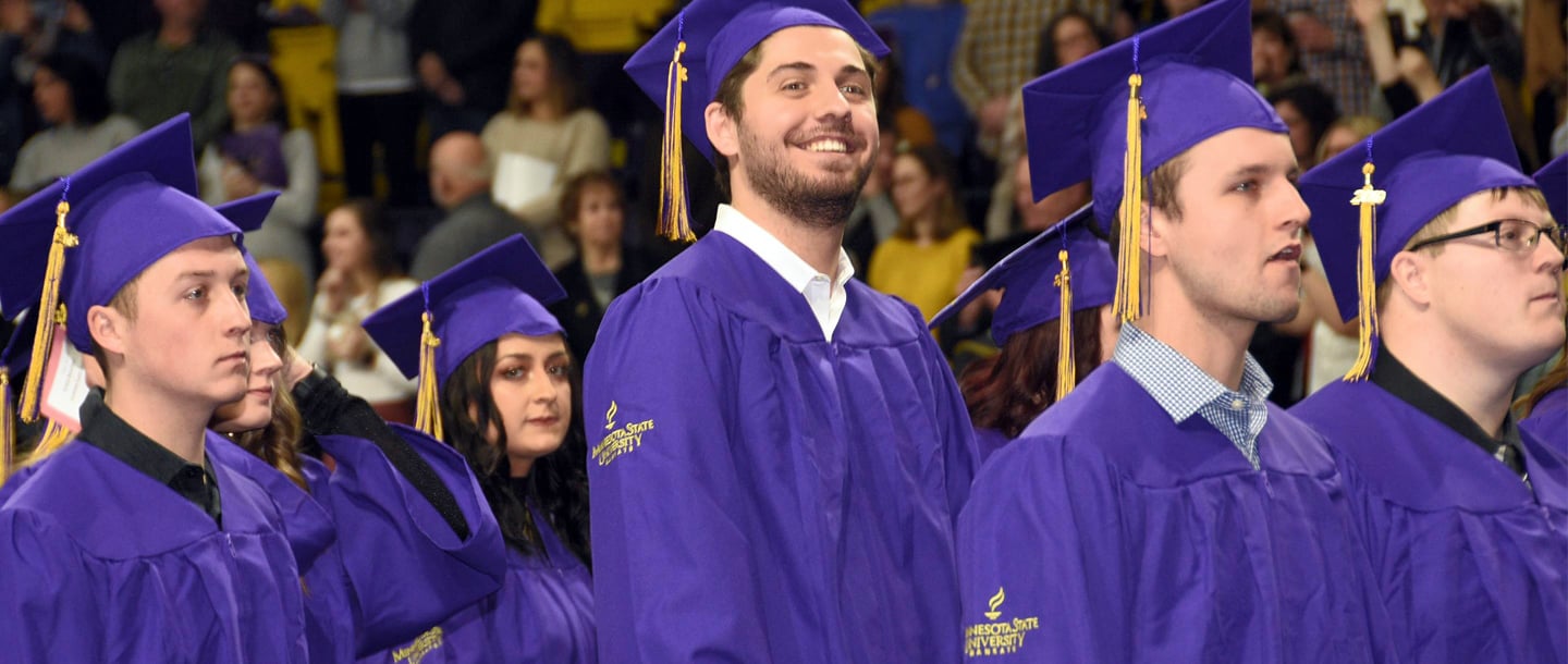 Closeup of graduates standing at the commencement ceremony
