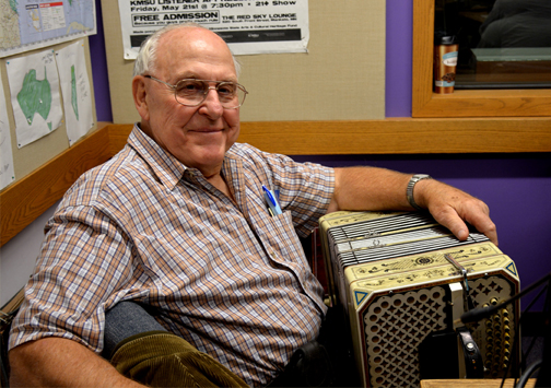 a person sitting in a chair with an accordion