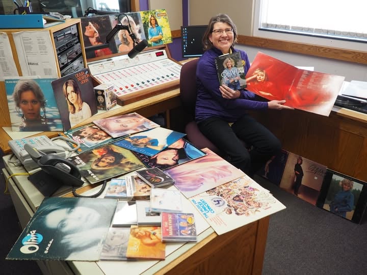 KMSU host Karen Wright in the KMSU studios with her very large collection of Olivia Newton John Records
