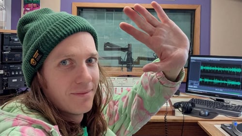 KMSU host Will Bjorndal waving goodbye to the camera in a radio studio
