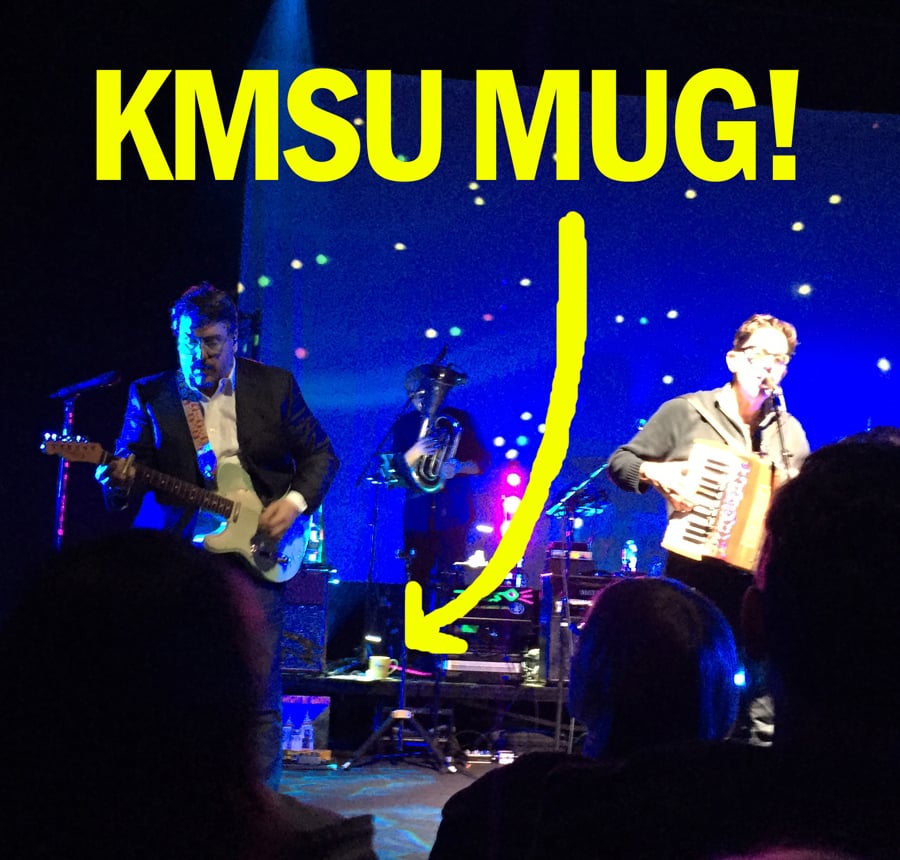 They might be giants on stage with the KMSU mug on a drum riser behind them