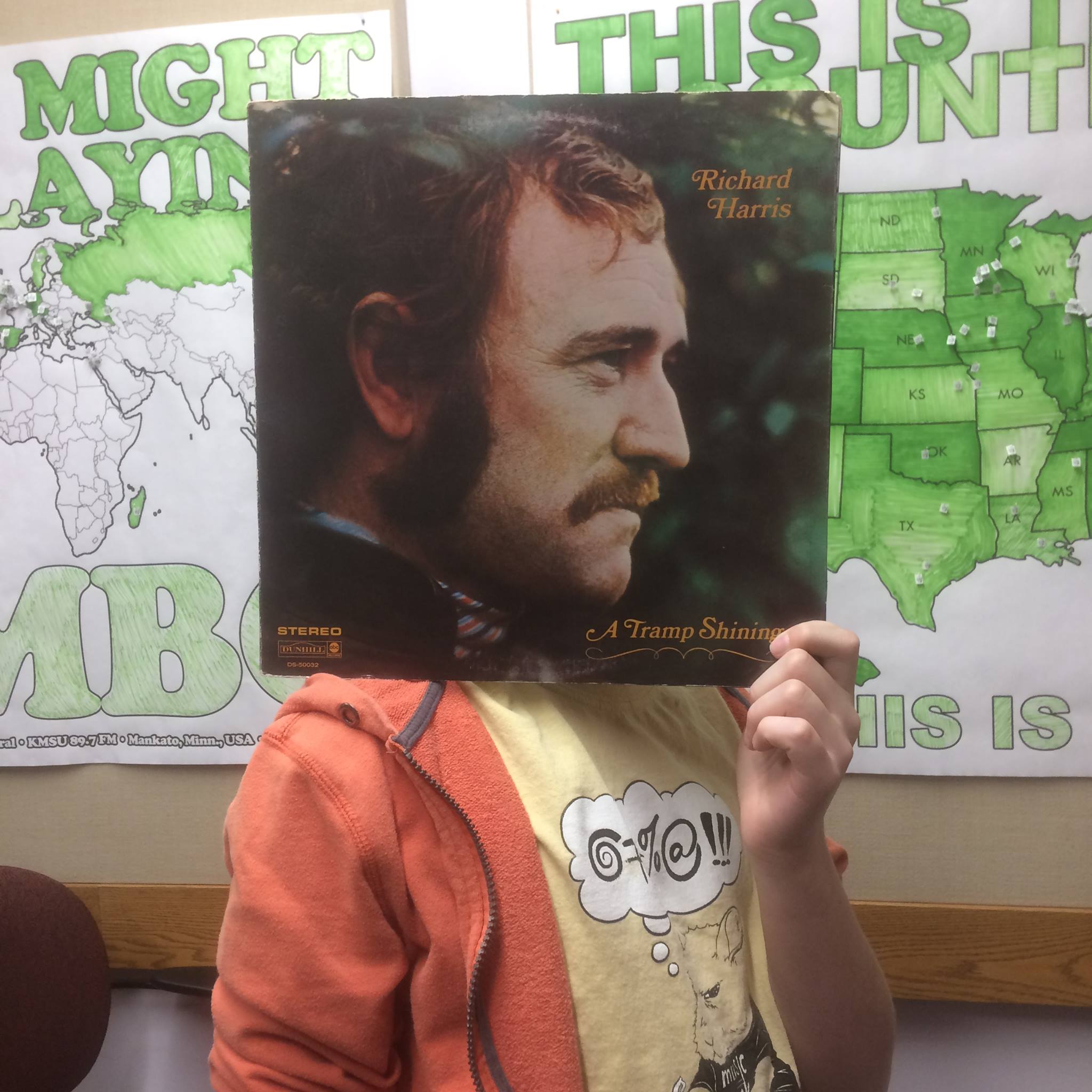A person holding an LP jacket of Richard Harris' A Tramp Shining up over their face