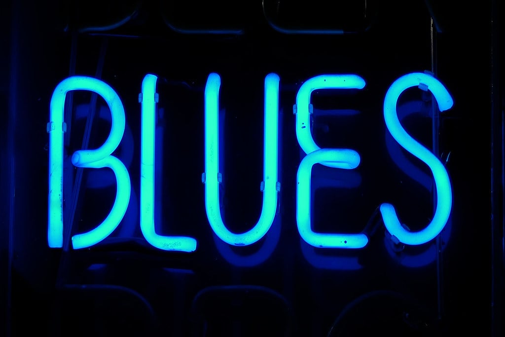 a blue neon sign with text
