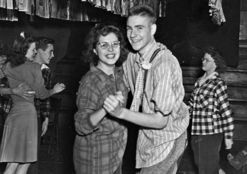 Vintage black and white photo of teens dancing at a school dance