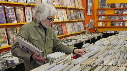 Gary Campbell browsing record bins at a music store