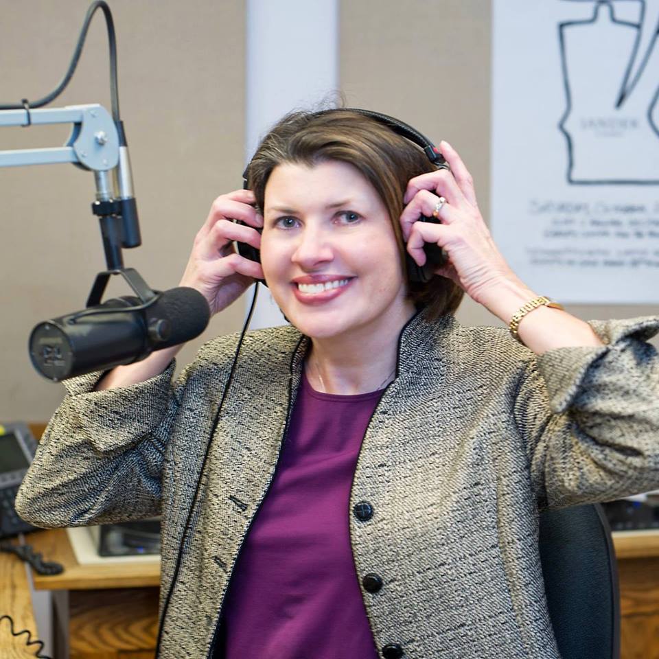 KMSU host Karen Wright puts headphones on in the KMSU broadcast booth