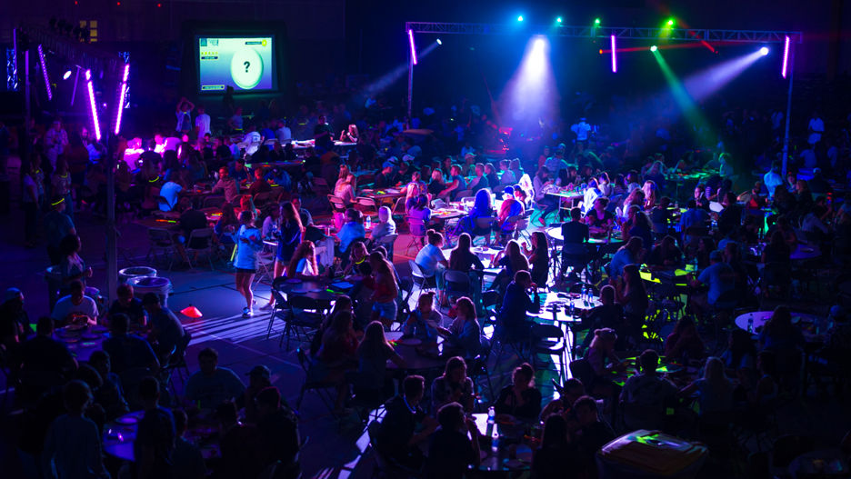 View of the Cosmic Bingo night with engaged students and a light show in the Myers Fieldhouse