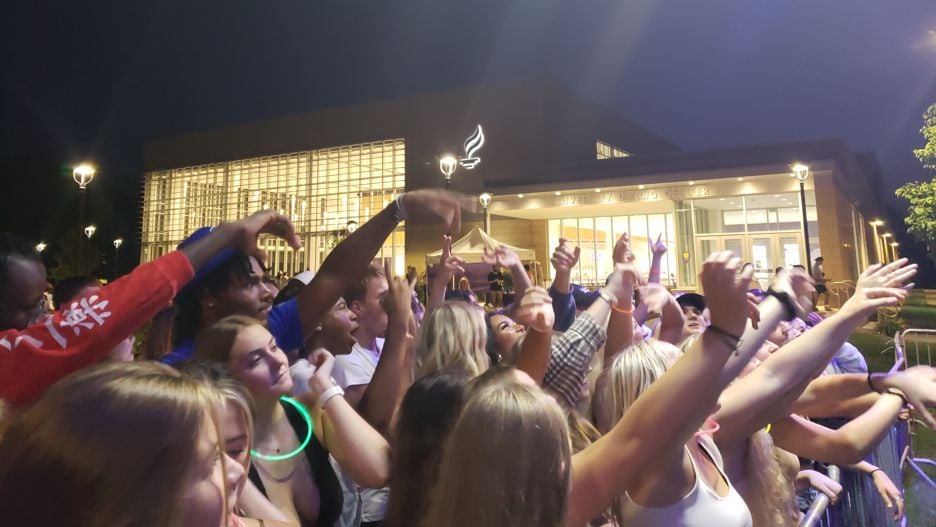 Students outside on campus dancing and cheering during the 2021 Mav Fest