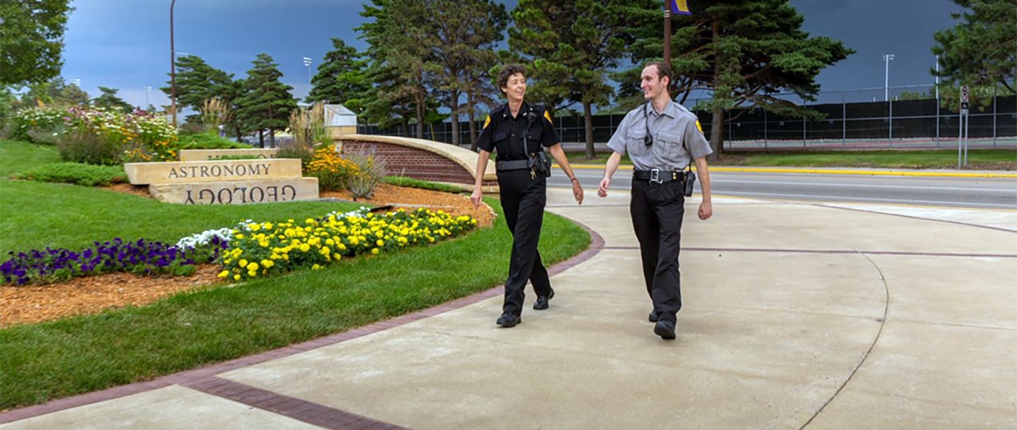 Campus security staff walking outside around the campus