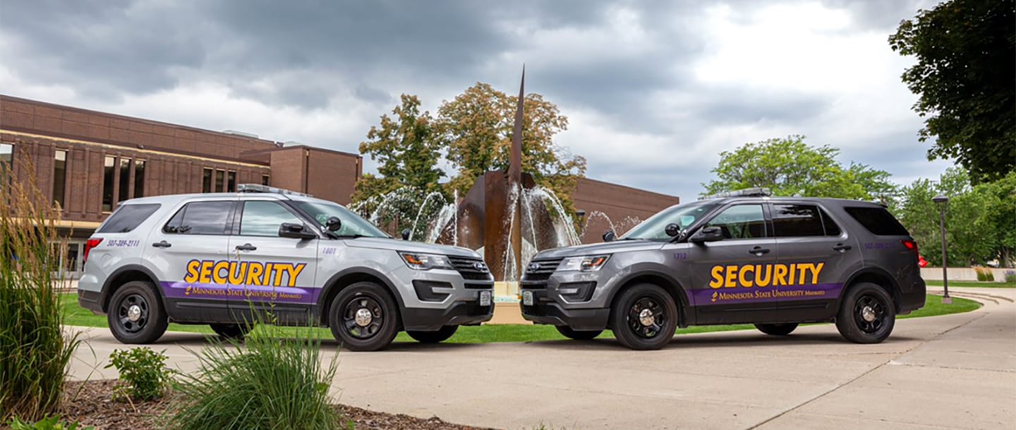 Campus security vehicles parked in front of the fountain