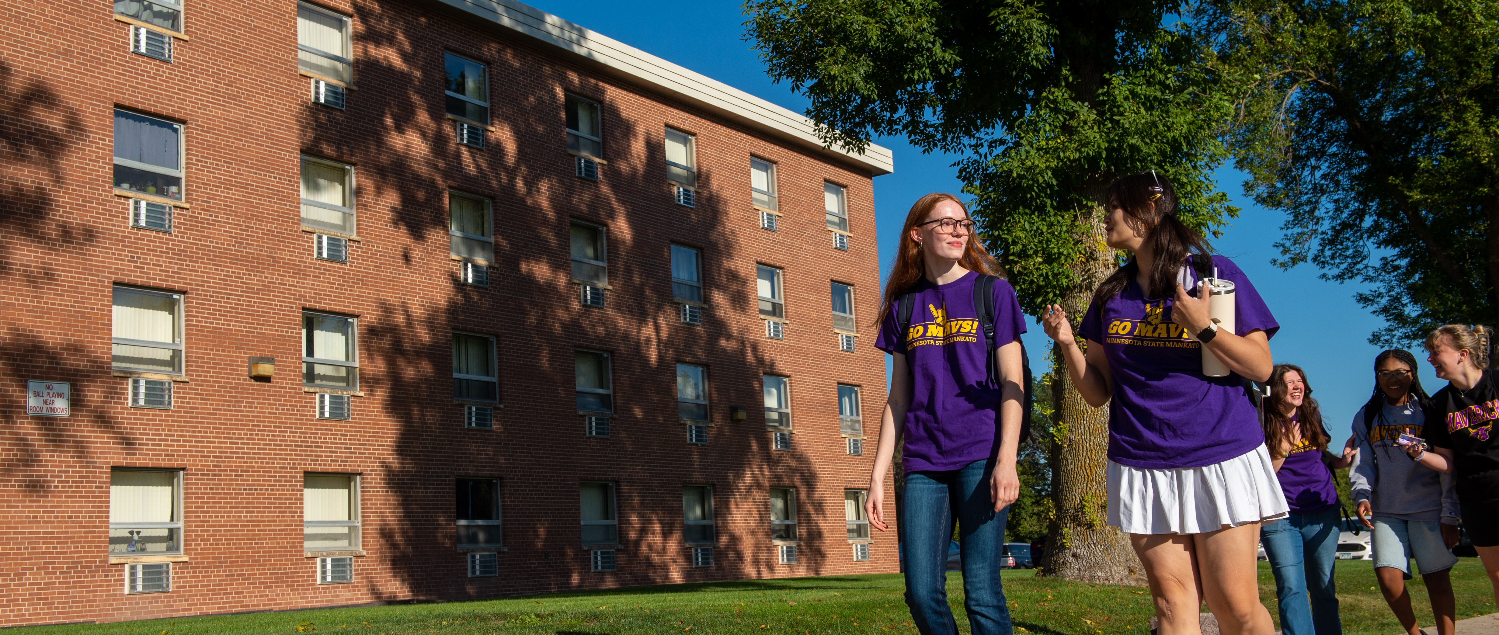 Girls walking outside of Crawford C Hall
