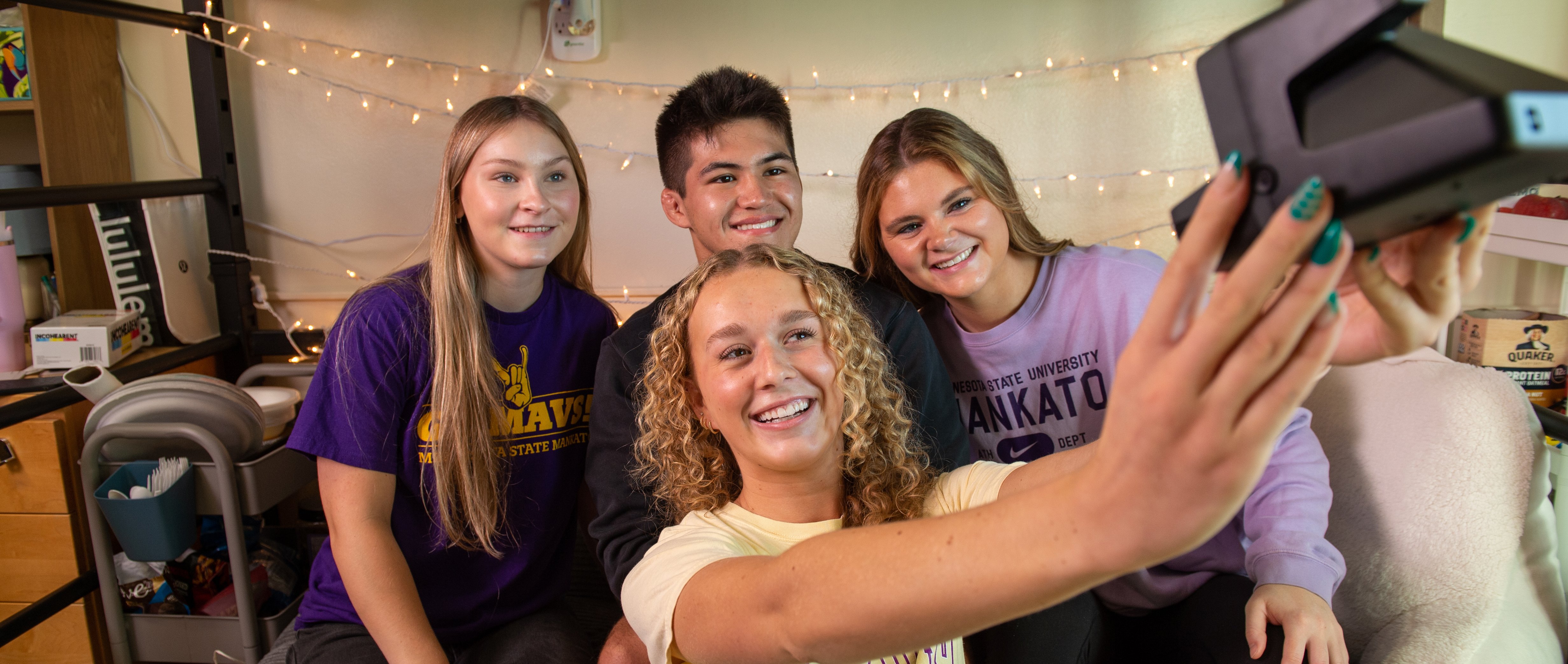Students taking a selfie with a polaroid camera