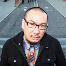 a person wearing glasses and a black jacket