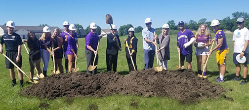 a group of people digging in the ground