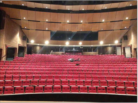 a large auditorium with red seats